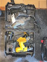 Overview of all tools including Rotozip spiral saw, Black & Decker planer, Dewalt drill inside the case