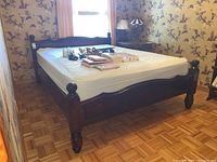Full assembled bed frame with mattress showing headboard and footboard