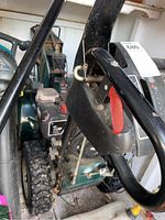 Snow blower handle assembly showing red safety lever and lot sticker