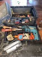 Open Mastercraft toolbox showing contents including impact drill, measuring tapes, hand tools