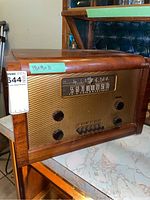 Front and side view of Marconi vintage radio with wooden cabinet, measuring approximately 18x9x11 inches with gold-tone mesh grille and analog tuning dial.