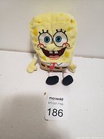 Front view of SpongeBob SquarePants plush stuffed toy on white surface against white background