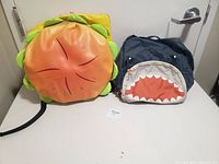 Image showing two kids backpacks, one hamburger shaped and one navy blue with shark mouth design