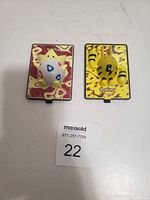 Front view of two Pokemon 3D figurine cards featuring Togepi and Electabuzz on colorful backgrounds.