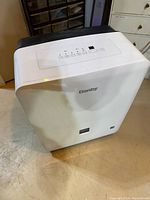 Image showing the white Danby dehumidifier standing on a floor with a digital control panel on top.