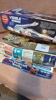 Stack of three vintage model kits showing titles and partial art: Visible Woman, First Lunar Landing, The Human Body