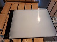 Top view of NorthernLight Tech SADS lightbox showing frosted translucent white top panel with black frame and power switch.