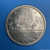 Obverse side of 1966 Canadian Silver Dollar showing canoe scene with two men and date 1966.