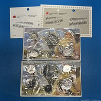 Two Canadian Mint proof coin sets sealed in cellophane with official papers and envelopes visible