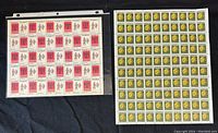 Photo showing full sheets of 6 cent and 8 cent Canadian stamps in protective sleeves against a dark fabric background.