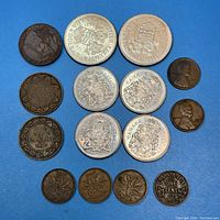 Photo showing various Canadian coins including nickel dollars dated 1927 and 1951, half dollars, small cents from early 20th century, and USA pennies mixed in, all circulated with wear.