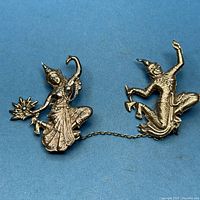 Front view of the complete double dancer brooch showing both figures and chain
