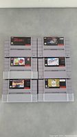 Six SNES game cartridges arranged in two columns of three showing front labels of each game