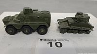 View of both toy military vehicles side by side showing condition and details