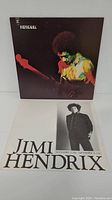 Vinyl LP album cover showing Jimi Hendrix playing guitar with promotional poster featuring concert dates below.