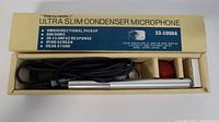 Original box containing the Ultra Slim Condenser Microphone with cable and red foam windscreen inside.