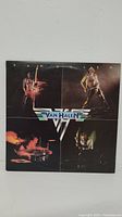 Front cover of Van Halen self-titled vinyl LP showing four band members in performing poses.
