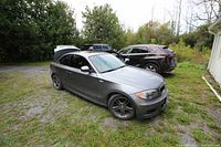 Front three-quarter exterior view of silver 2-door coupe parked outdoors.