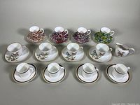 All 12 cups and saucers including demitasse and creamer displayed showing different patterns and colors