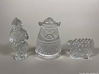 The three clear glass pieces together showing the Viking ship, Nordic figure with helmet, and another Nordic man figure with textured details.