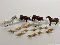 Full set of 18 Hornby metal farm animal figurines including horses, cows, pigs, and sheep arranged on white background.