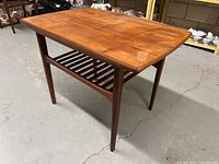 Three-quarter view of teak table top and legs