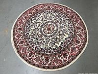 Full overhead view of the round vintage wool rug showing the entire pattern and color scheme.