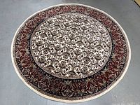 Full view of the round wool rug on concrete floor