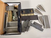 Box with various platform components including staircases, ramps, and platform extensions laid out beside box