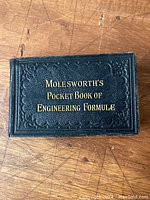 Front cover of the antique book with embossed title 'Molesworth's Pocket Book of Engineering Formulae' in gold lettering on leather cover.