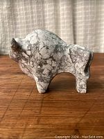 Side view of the vintage carved marble bull sculpture, showcasing the fine grain white and grey marble pattern and smooth minimalist carving details.