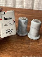 Pair of marble salt and pepper shakers along with original box showing design by Knut Hagberg and Marianne Hagberg for IKEA