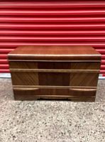 Front view of the vintage Art Deco waterfall cedar chest showing wood veneer design and bottom drawer.