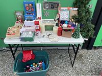 Overview of the Christmas decorations including ornaments, candles, artificial trees, and boxed sets.