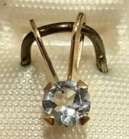 Close-up of the aquamarine gemstone in the 14K gold prong setting.