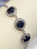 Close-up image showing the three oval sapphire stones surrounded by CZ stones and the sterling silver setting in the bracelet.