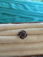 Close-up top view of the vintage sterling silver ring showing square druzy stone center and purple marquise stones forming a floral pattern.