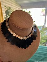 Front view of the necklace showing the full fan-shaped hematite and metal-toned design