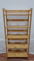 Front view of the 5 shelf folding wooden bookcase, showing all shelves and wood grain.