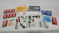 Full overview of lot items arranged on white surface showing manuals, tools, hardware, and small accessories.