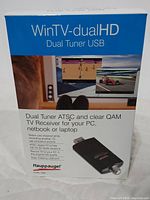 Front and side view of the WinTV dual HD dual tuner USB TV receiver box showing key features and branding.