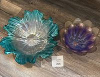 Top down view of both the aqua Walther Glass Marrakech bowl and the purple flower-shaped glass plate