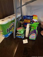 Full view of all cleaning supplies including Bounty paper towels, Finish dishwasher tablets, spray cleaners, cleaning cloths and stainless steel wipes.