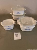 Full set of Corning Ware dishes with visible blue cornflower pattern and 3 glass lids, two with visible cracks.
