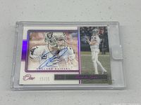 Front view of Derek Carr signed football card showing Oakland Raiders uniform, autograph in blue ink, serial number 25/25, Panini One branding, and protective plastic case.