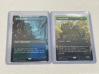 Photo of Breeding Pool and Protean Hulk cards in protective sleeves showing card text and artwork.