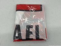 Folded Michael Jordan Chicago Bulls flag in original sealed plastic packaging showing partial text and team colors.