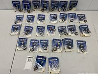 Full view of all 26 unopened Toronto Maple Leafs mini hockey pucks arranged on a white surface in original packaging