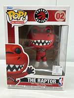 Front view of unopened box showing The Raptor Funko Pop figure with clear display, branding, and label 02.