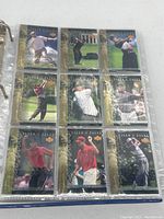 Page displaying nine 'Tiger's Tales' Tiger Woods Upper Deck cards in plastic sleeve.